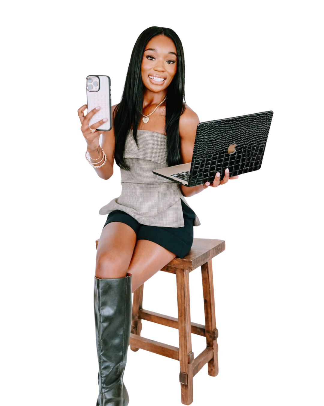 Attiya Smith holding a phone and laptop