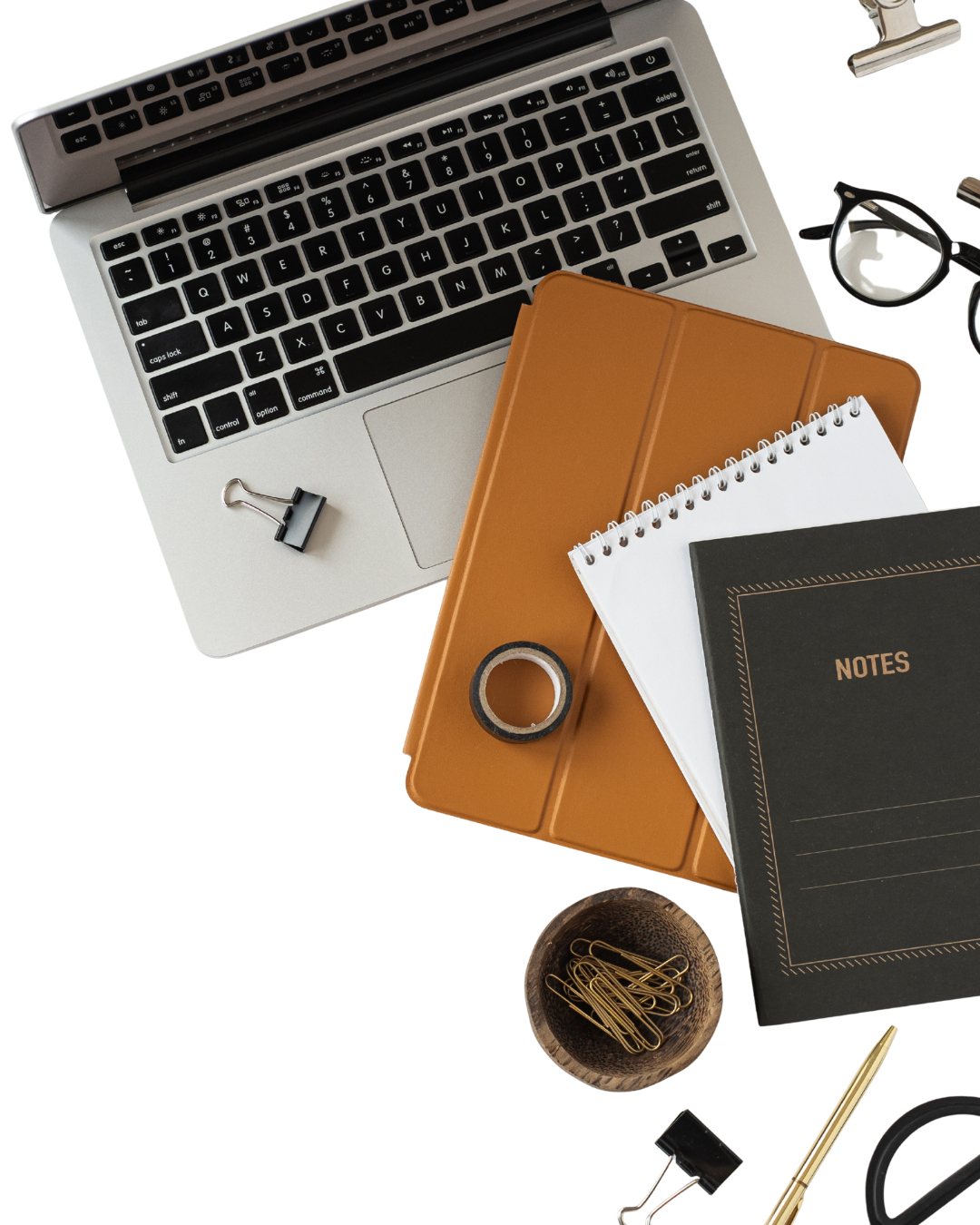 Desk with a laptop, notebook and planning tools